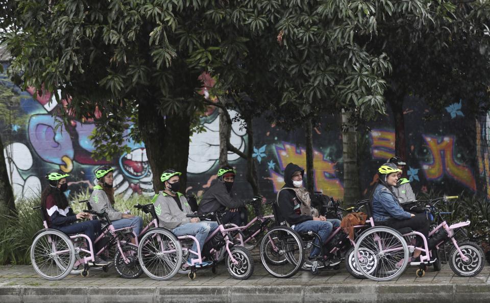 Tourists in electric wheelchairs ride at a park in Medellin, Colombia, Wednesday, Nov. 18, 2020. These weekly wheelchair tours are the latest tourist attraction in a city that is slowly shedding its reputation for drug violence and has become one of Colombia’s most-visited destinations. (AP Photo/Fernando Vergara)