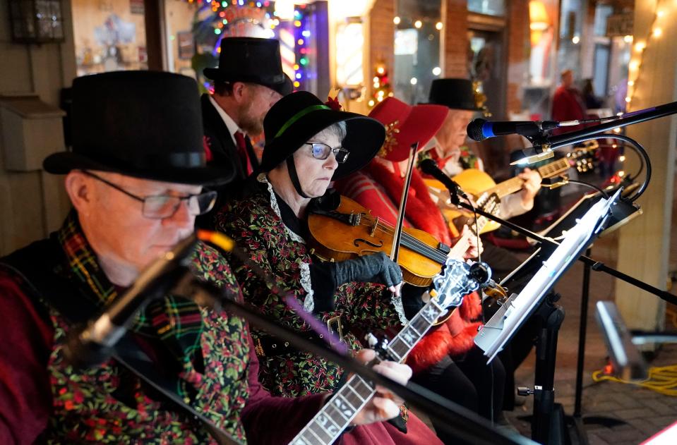 The Taylorville Methodist String Band performs during the Dickens Downtown celebration on Main Ave. in Northport Wednesday, Dec. 5, 2023.