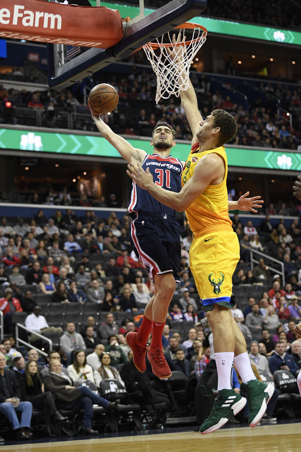 Washington Wizards guard Tomas Satoransky (31) goes to the basket against Milwaukee Bucks center Brook Lopez (11) during the first half of an NBA basketball game, Saturday, Feb. 2, 2019, in Washington. (AP Photo/Nick Wass)