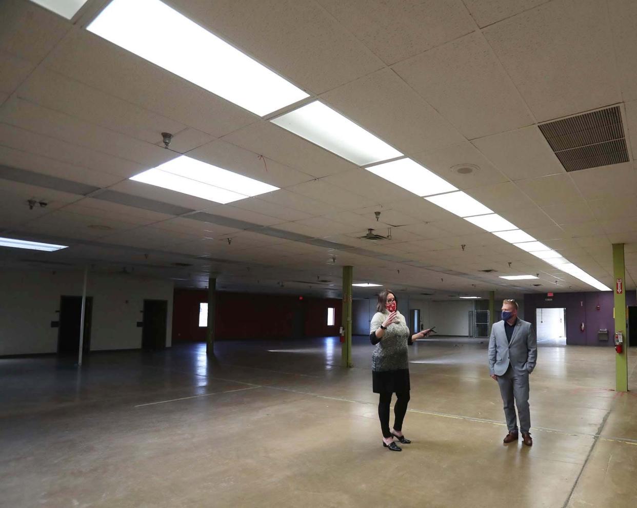 Lori L. Pesci, left, Deputy Director of the Division of Public Safety for the Summit County Executive's Office and Justin Fye, project architect for Mann, Parsons, Gray Architects walk through the former site of the Weaver Workshop that will become the new regional dispatch center.