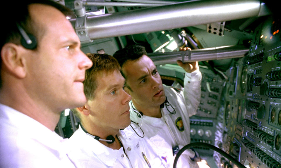 Bill Paxton, Kevin Bacon, and Tom Hanks looking at the motherboard.