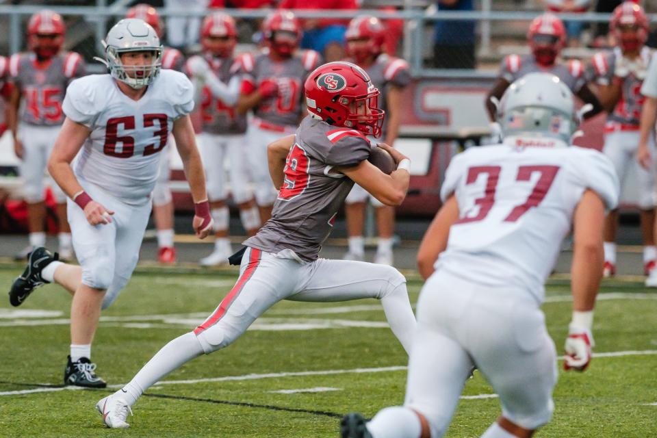 Canton South quarterback Poochie Snyder scrambles against Dover, Friday, Aug. 25, 2023.