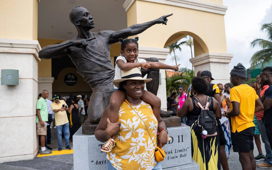 Kaydene Green and her daughter, Amelia Green, 6, are photographed in front of the newly unveiled bronze sculpture of Olympic gold medalist Usain Bolt at the Ansin Sports Complex on Saturday, July 15, 2023, in Miramar, Fla.