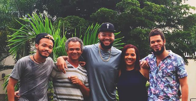 <p>Rorrey Fenty/Instagram</p> Rihanna's brothers Rajad (left) and Rorrey (center) with their father Ronald and other siblings