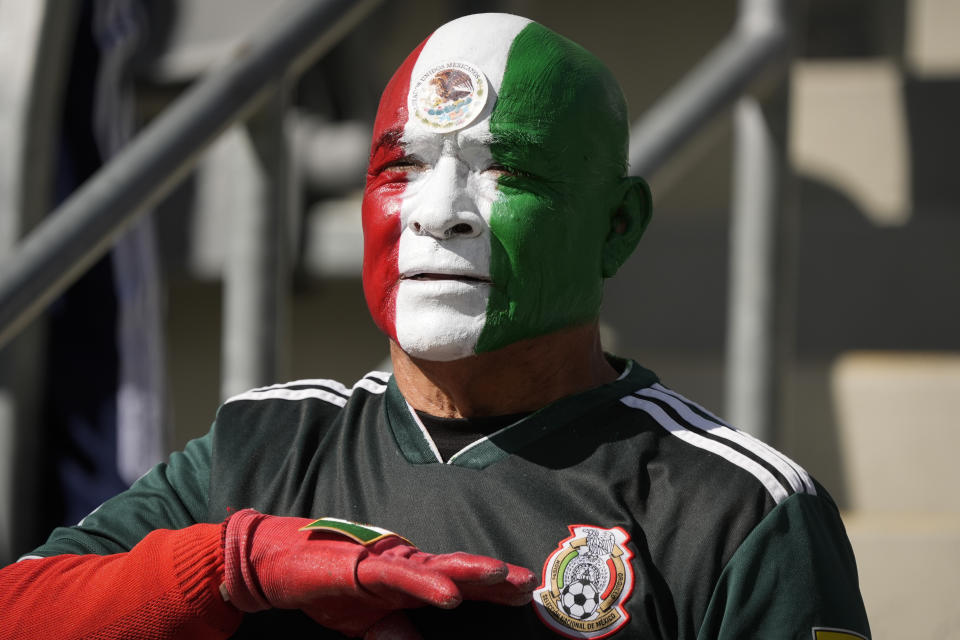A Mexico fan listens to their country's national anthem before a CONCACAF Gold Cup women's soccer tournament quarterfinal against Paraguay, Sunday, March 3, 2024, in Los Angeles. (AP Photo/Marcio Jose Sanchez)