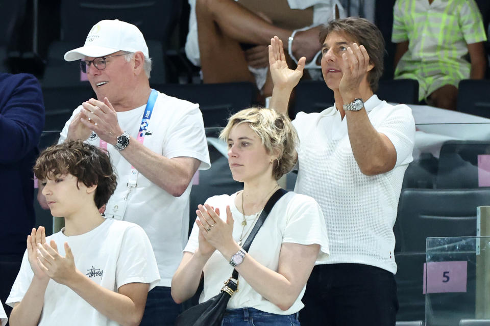 Tom Cruise (R), Greta Gerwig and David Zaslav watch the women's gymnastics preliminaries on day two of the Paris 2024 Olympic Games at the Bercy Arena in Paris, France on July 28, 2024. (Photo by Arturo Holmes/Getty Images)