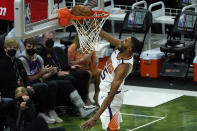 Phoenix Suns forward Mikal Bridges (25) dunks against the Milwaukee Bucks during the second half of Game 3 of basketball's NBA Finals in Milwaukee, Sunday, July 11, 2021. (AP Photo/Paul Sancya)