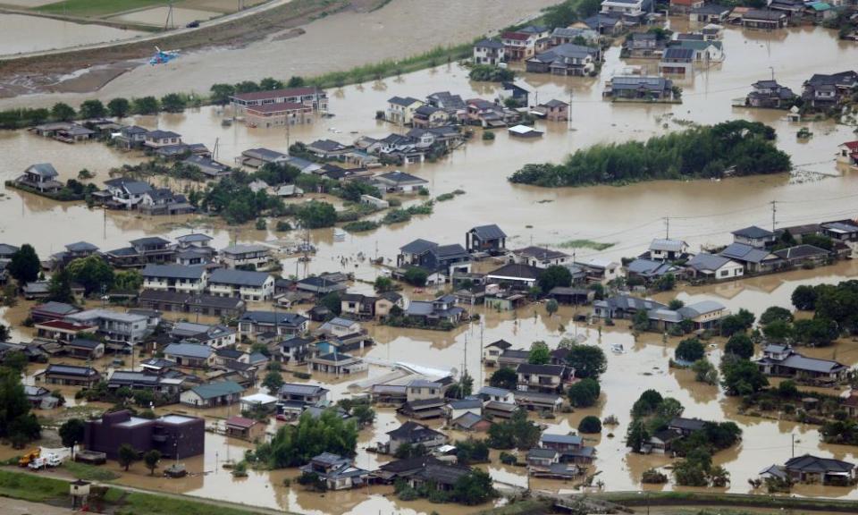 An aerial view of flooded homes in southwestern Japan, where more than 50 people have died as a result of the extreme weather.