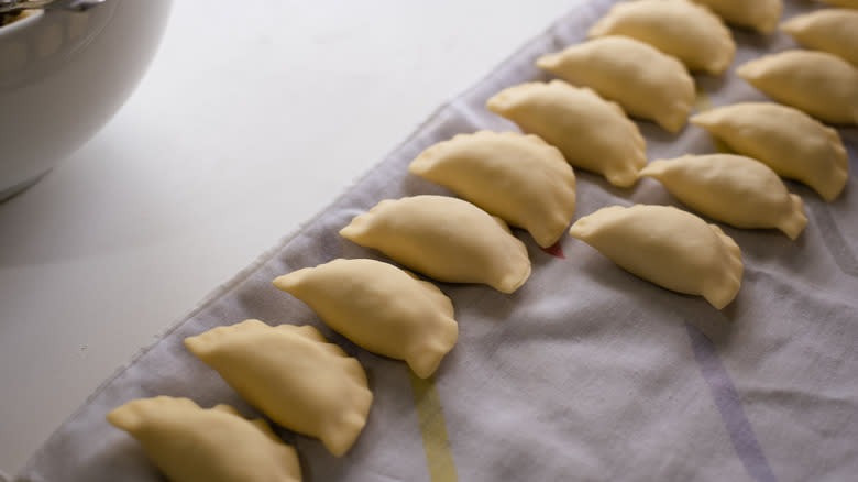 Rows of uncooked pierogi