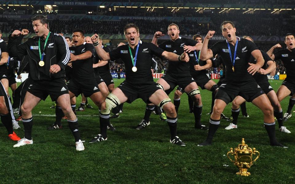 In this file photograph taken on October 23, 2011, New Zealand All Blacks including captain Richie McCaw (C) perform a victory Haka behind the Webb Ellis Cup after they won the 2011 Rugby World Cup final match against France at Eden Park Stadium in Auckland - Franck Fife/AFP/Getty Images