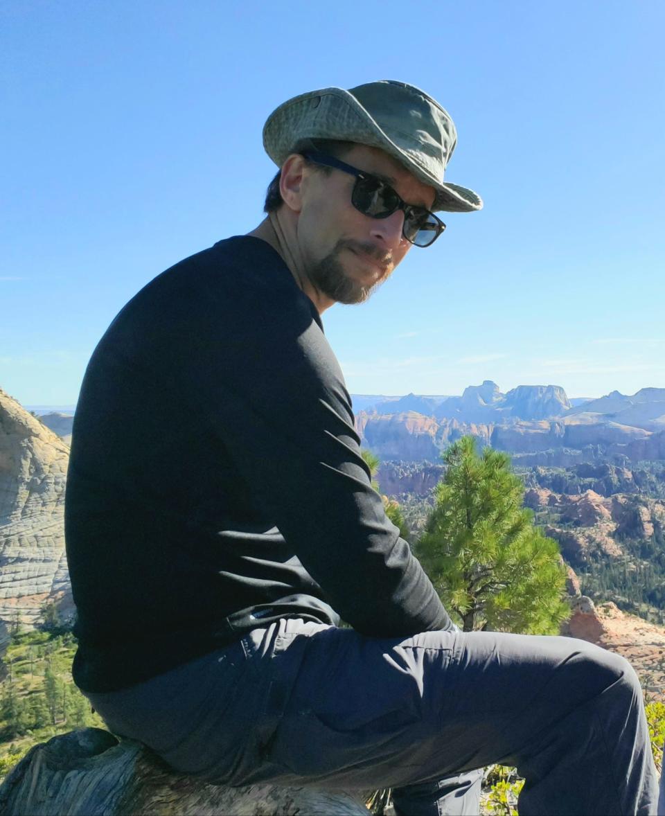 Rob Byers sits atop the east peak, at the end of the Northgate Peaks Trail in Zion National Park.