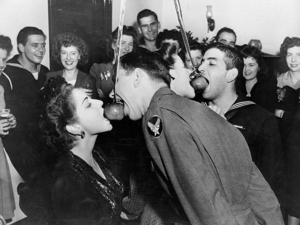 Adults bobbing for apples in 1943.