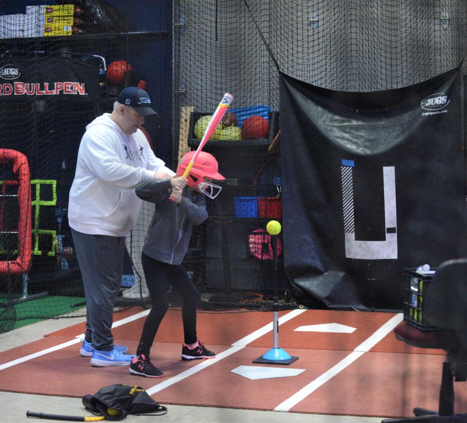 Michael Hague provides instruction to Chloe Unger at Elevate to Celebrate. Michael said the family business is certified by On Base University, which offers physical assessments and training plans for baseball and softball players.