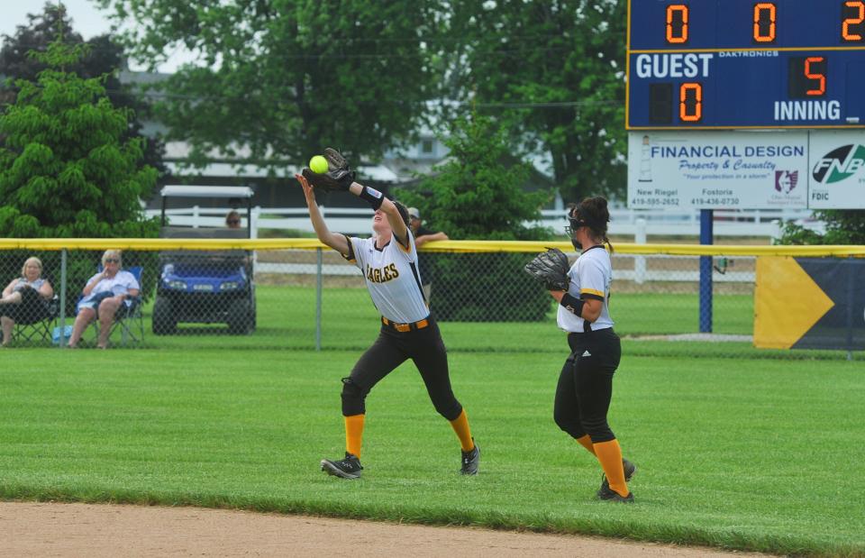 Colonel Crawford's Alivia Studer snags a shallow fly out to centerfield with Kaylyn Risner nearby.