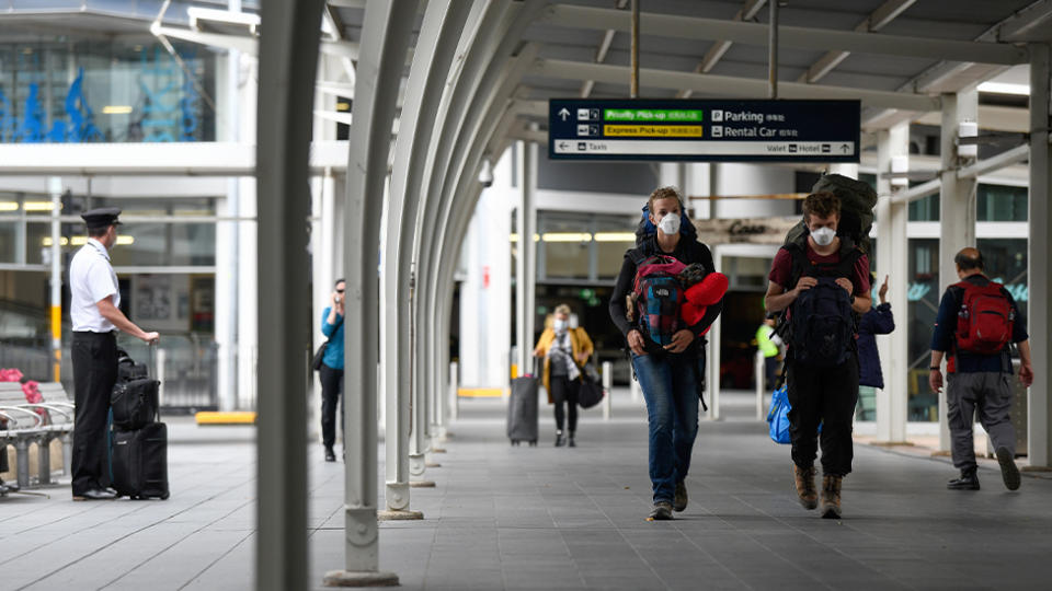 People are seen wearing masks after arriving at Sydney's airport. Source: AAP