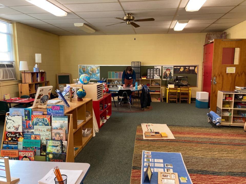 Sasha Skau sets up at a Feb. 4, 2023 open house for Mountain City Public Montessori in downtown Asheville.