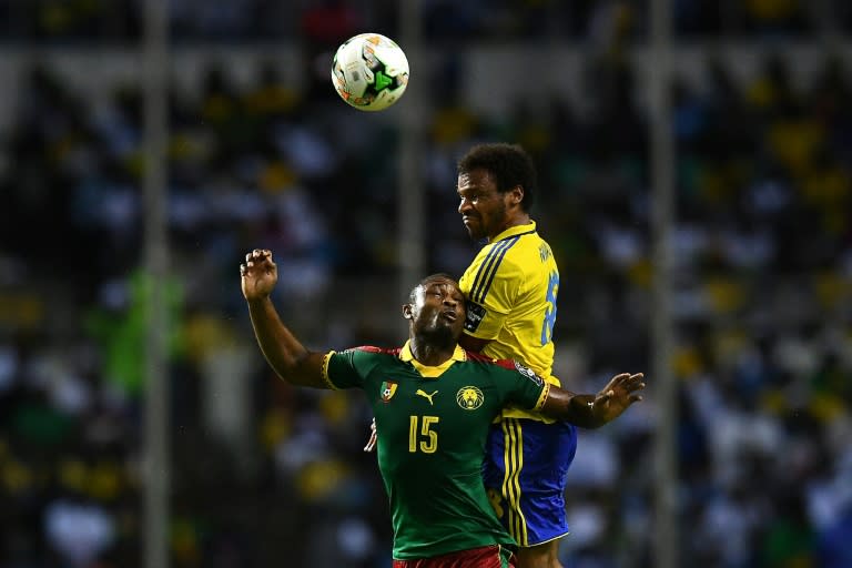 Cameroon's midfielder Sebastien Siani heads the ball with Gabon's midfielder Junior Serge Martinsson Ngouali (back) during the 2017 Africa Cup of Nations group A football match between Cameroon and Gabon on January 22, 2017