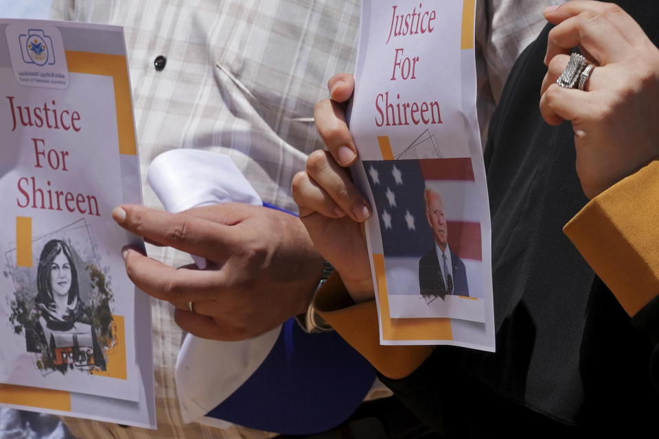 Palestinian journalists hold pictures of U.S. President Joe Biden and slain Palestinian-American journalist Shireen Abu Akleh during a sit-in protest in Gaza City, Wednesday, July 13, 2022. The protest, which coincides with the arrival of U.S. President Joe Biden to Israel, demands justice for the veteran Al Jazeera reporter who was shot dead while covering an Israeli army raid in the West Bank in May. (AP Photo/Adel Hana)