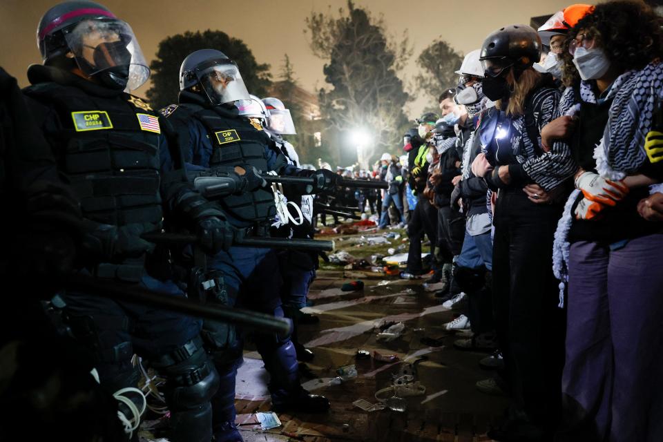 Police face-off with pro-Palestinian students after destroying part of the encampment barricade on the campus of the University of California, Los Angeles (UCLA) in Los Angeles, California, early on May 2, 2024. Police deployed a heavy presence on US university campuses on May 1 after forcibly clearing away some weeks-long protests against Israel's war with Hamas.