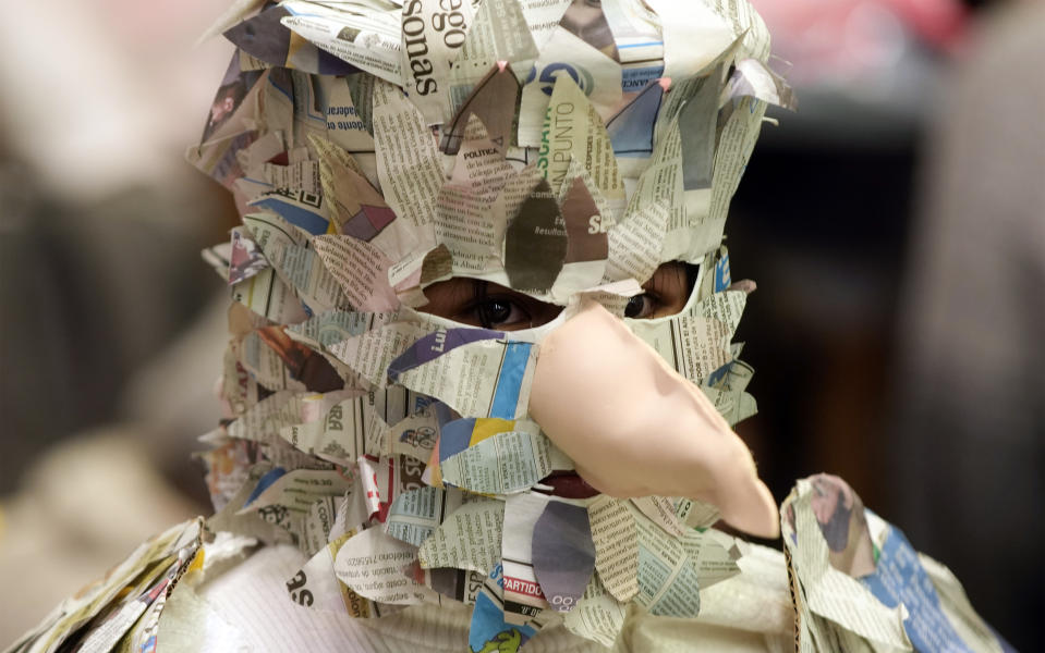 A youth in a bird costume made of newspapers dances the "Leque leque," the Aymara Indigenous word for a particular bird, at an event featuring Indigenous and folkloric dances, organized by the Special Education Center for youths with special needs in La Paz, Bolivia, Wednesday, Oct. 12, 2022. (AP Photo/Juan Karita)