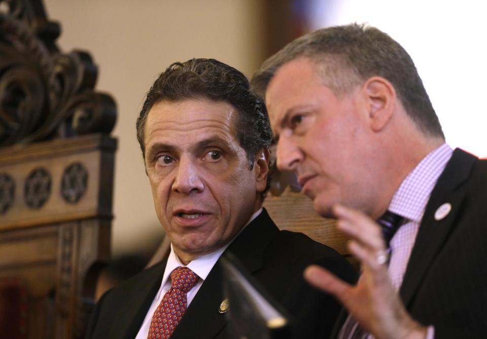 FILE - In this Feb. 16, 2014, file photo, New York Gov. Andrew Cuomo, left, and New York City Mayor Bill de Blasio attend a Black, Puerto Rican, Hispanic and Asian Legislative Caucus Weekend church service at the Wilborn Temple in Albany, N.Y. De Blasio’s first 100 days as mayor of NYC were marked in nearly equal measures by accomplishing campaign goals and committing political blunders. Most of his time and energy was spent on his signature campaign promise - to tax the city’s rich to pay for universal pre-K. That resulted in only a partial victory after the surprise entry of Cuomo, who rejected the tax idea and offered to fund pre-kindergarten through the state budget. (AP Photo/Mike Groll, File)