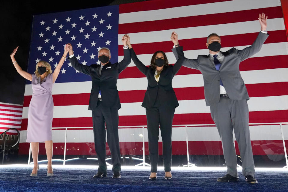 FILE - In this Aug. 20, 2020, file photo Democratic presidential candidate former Vice President Joe Biden, and his wife Jill Biden, join Democratic vice presidential candidate Sen. Kamala Harris, D-Calif., and her husband Doug Emhoff, during the fourth day of the Democratic National Convention at the Chase Center in Wilmington, Del. (AP Photo/Andrew Harnik, File)