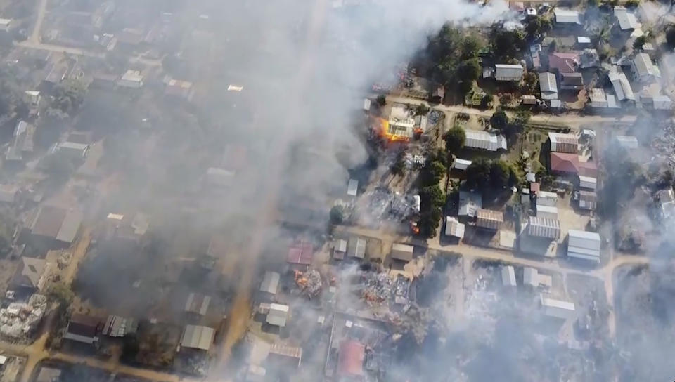 In this image taken from drone video provided by Free Burma Rangers, smoke arises from burning buildings in Waraisuplia village in Kayah State, Myanmar on Feb. 18, 2022. While Russia’s war in Ukraine dominates global attention, Myanmar’s military is targeting civilians in air and ground attacks on a scale unmatched in the country since World War II, according to a longtime relief worker who spent almost three months in a combat zone in the Southeast Asian nation. (Free Burma Rangers via AP)