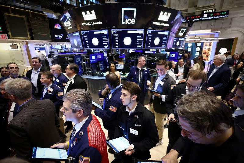 FILE PHOTO: Traders work on the trading floor at the New York Stock Exchange (NYSE) in New York City