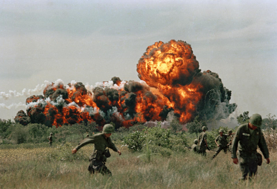 A napalm strike erupts in a fireball near U.S. troops on patrol in South Vietnam, 1966. (AP Photo)