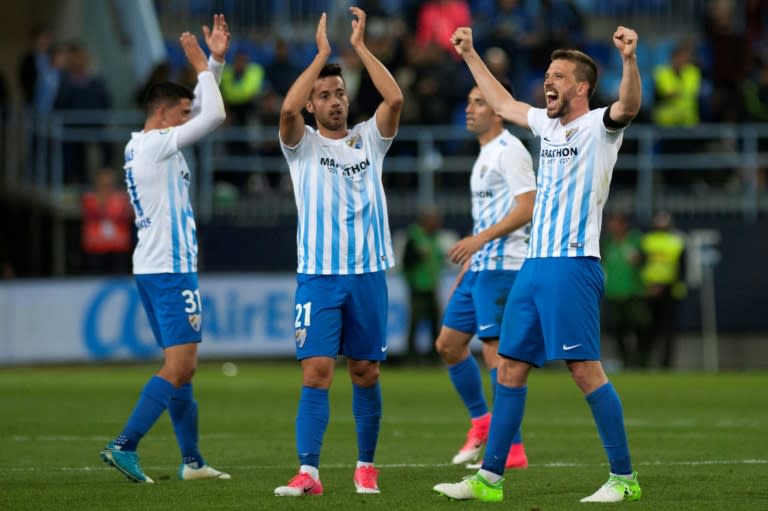 Malaga's players celebrates after winning 2-0 the Spanish league football match Malaga CF vs FC Barcelona at La Rosaleda stadium in Malaga on April 8, 2017