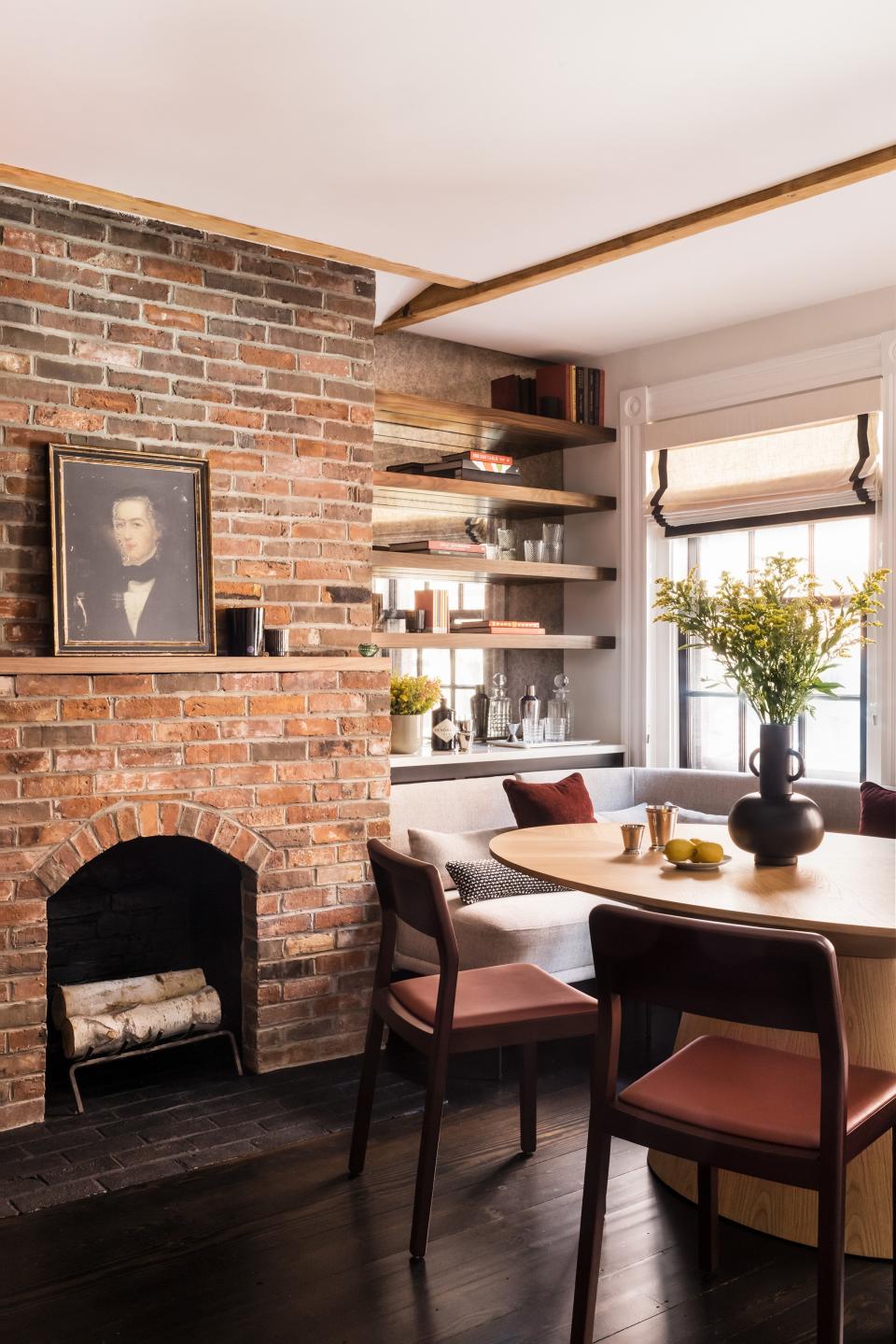 AFTER: The team removed the drywall that obscured the brick fireplace in order to establish symmetry. “The brick chimneys are the anchoring points in the newly joined space,” Dana says.