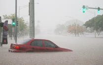 <p>A car is stuck partially submerged in floodwaters from Hurricane Lane rainfall on the Big Island on August 23, 2018 in Hilo, Hawaii. (Photo: Mario Tama/Getty Images) </p>