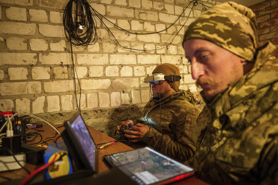 A Ukrainian serviceman of the ACHILLES battalion of the 92nd brigade operates a suicide drone over Russian positions in the Kharkiv region of Ukraine on Sunday, May 12, 2024. (AP Photo/Evgeniy Maloletka)