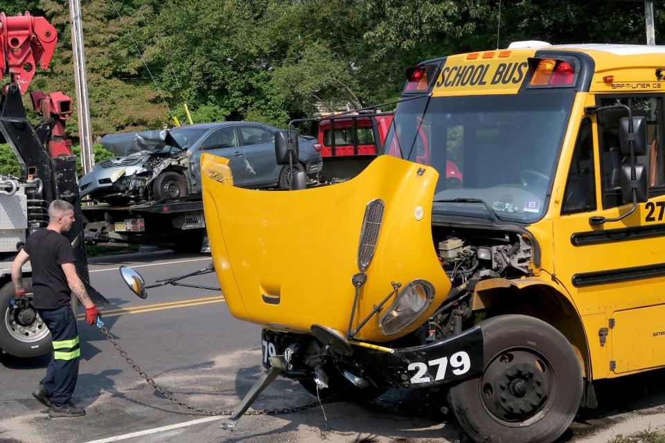 A Jay's Bus Company bus is readied to be towed from Forest Avenue, just south of 11th Street, in Lakewood Tuesday morning, September 14, 2021, where it was involved in a collision with at least three other cars. The bus was traveling south on Forest picking up girls attending the Bais Yaakov high school.