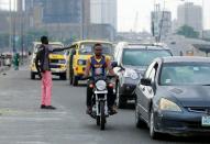 Cars drive along a road in Lagos