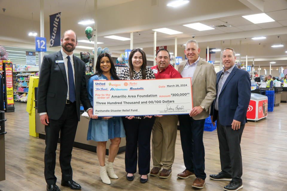 Members of The United Family, including United Supermarkets, present the Amarillo Area Foundation a check for wildfire disaster relief Thursday at the United Supermarket on 45th Avenue in Amarillo.