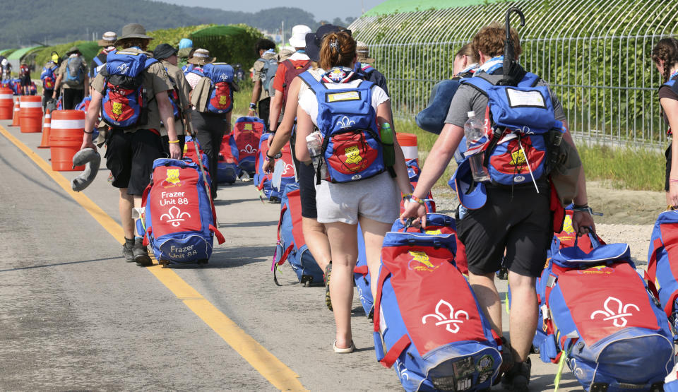 British scout members leave the World Scout Jamboree campsite in Buan, South Korea, Sunday, Aug. 6, 2023. South Korea is preparing to evacuate tens of thousands of scouts from a coastal jamboree site as Tropical Storm Khanun looms, world scouting officials said Monday. (Choe Young-soo/Yonhap via AP)