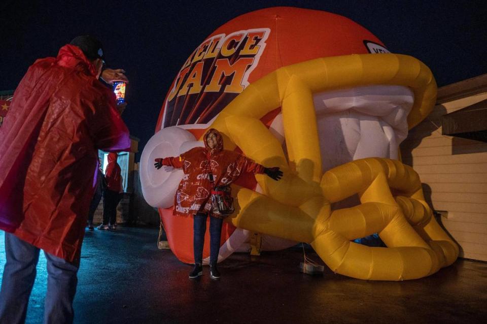 Jackie Smick poses for a photo next to an inflatable football helmet while attending Kelce Jam at the Azura Amphitheater on Friday, April 28, 2023, in Bonner Springs.