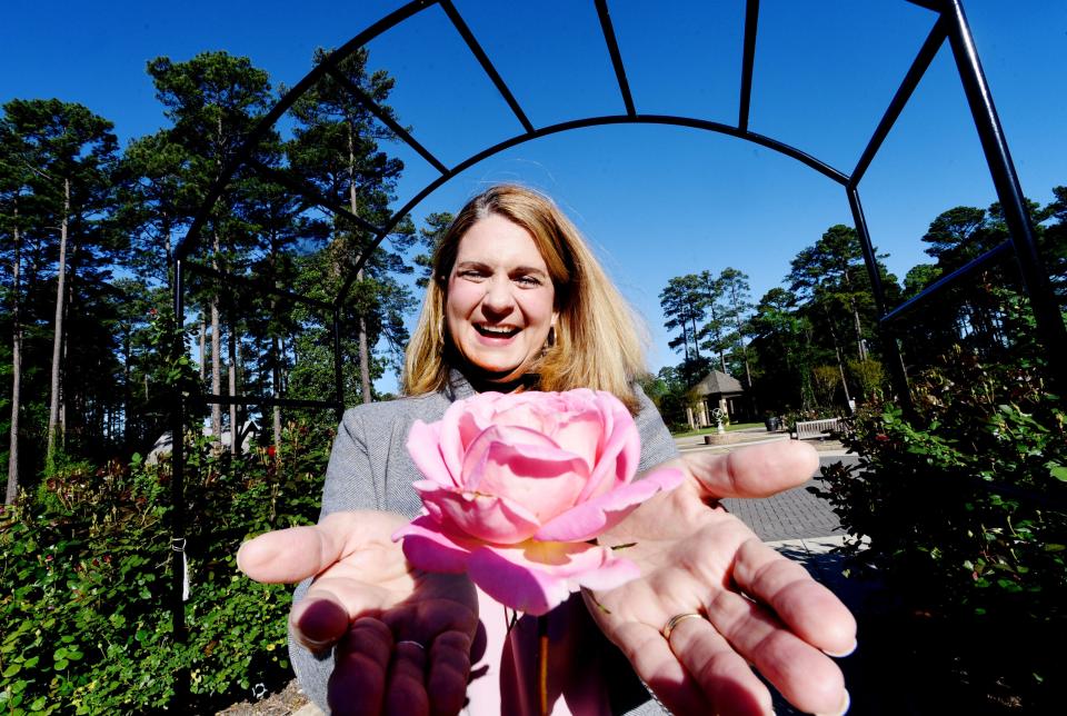 American Rose Society Executive Director Claire Bissell in the gardens with a Horace McFarland Rose on April 3, 2024.