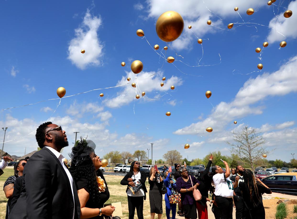 Donnell Smith and Ryan Smith, daughter of Santa Blair, watch a balloon release following a remembrance ceremony for Dr. Kenneth Wayne Blair, Sr., known as Santa Blair, at Life Church in Edmond, Okla. Saturday, April 6, 2024.