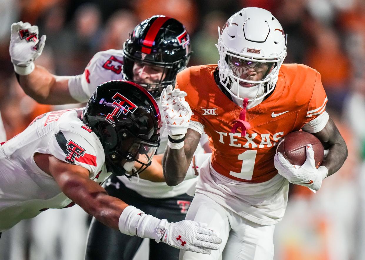 Texas wide receiver Xavier Worthy rolls into the end zone for a third-quarter touchdown during Friday night's 57-7 win over Texas Tech at Royal-Memorial Stadium.