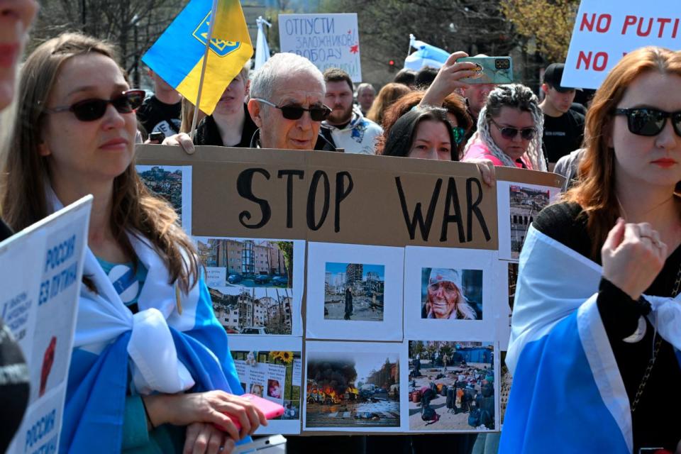 PHOTO: People take part in an anti Putin rally as voters queue outside the Russian embassy in Washington, DC, on March 17, 2024.  (Roberto Schmidt/AFP via Getty Images)