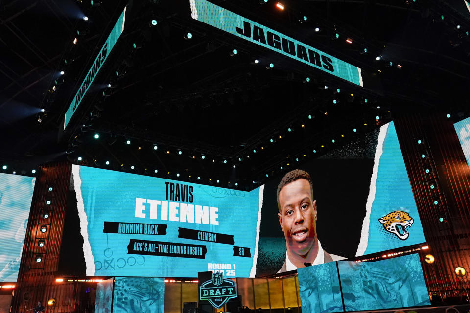 An image of Clemson running back Travis Etienne is displayed on stage after he was chosen by the Jacksonville Jaguars with the 25th pick in the first round of the NFL football draft Thursday April 29, 2021, in Cleveland. (AP Photo/Tony Dejak)