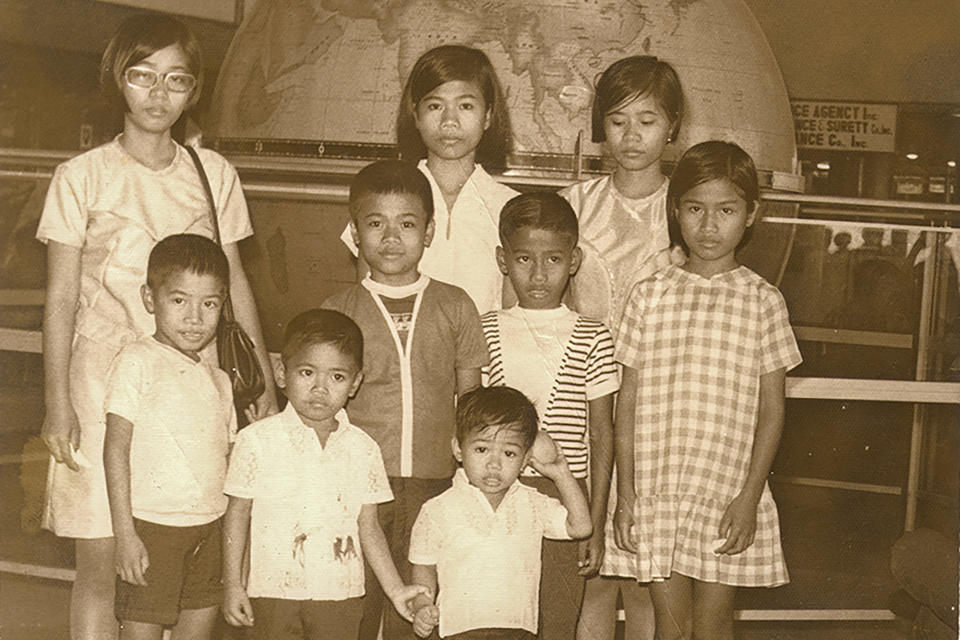 Preparing to leave for Hawaii from Manila, Philippines, four-year-old Bobby Calvan, front left, holds his younger brother's hand while posing for a portrait with his siblings in this December 1969 photo. (Courtesy Calvan Family via AP)