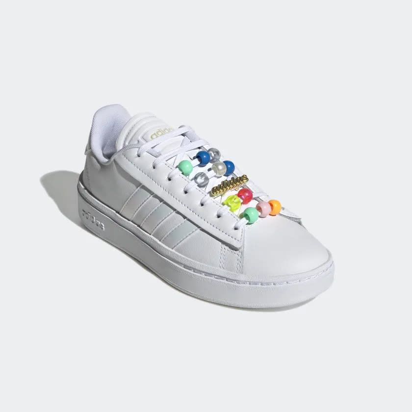 White sneakers with beads on laces.