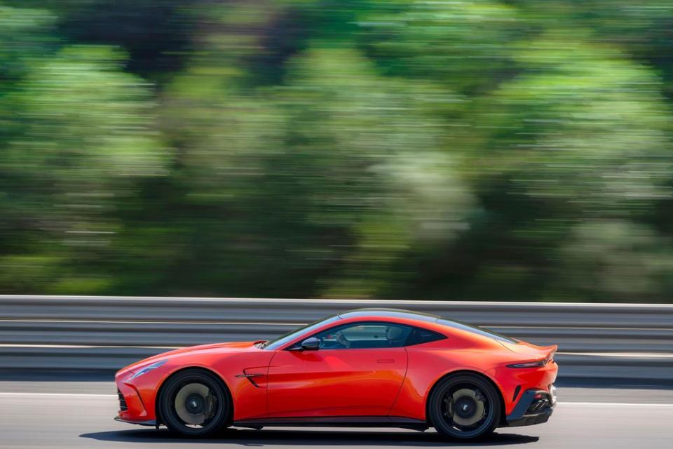 a red sports car driving on a road