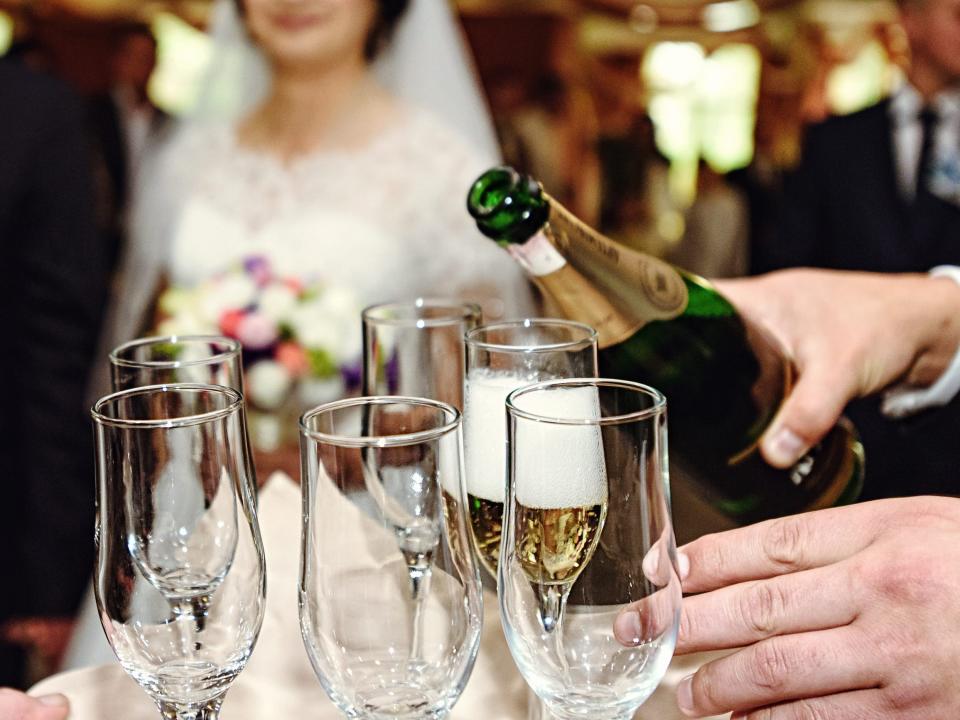 pouring champagne for a toast at a wedding