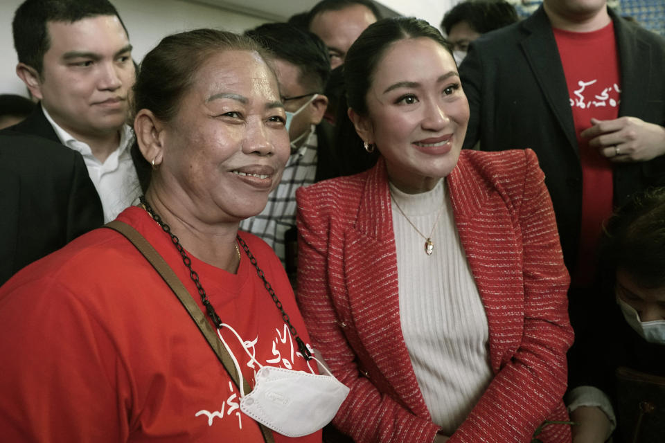 Paetongtarn Shinawatra, right, a leader of Thailand's opposition Pheu Thai Party, takes a picture with a supporter at Thammasat University's indoor gymnasium in Pathum Thani province, north of Bangkok, Thailand, on Friday, March 17, 2023. The Pheu Thai Party is heavily favored to win the most seats in the May 14 general election, and Paetongtarn, daughter of former Prime Minister Thaksin Shinawatra, is one of its three nominees to become the next prime minister. (AP Photo/Sakchai Lalit)