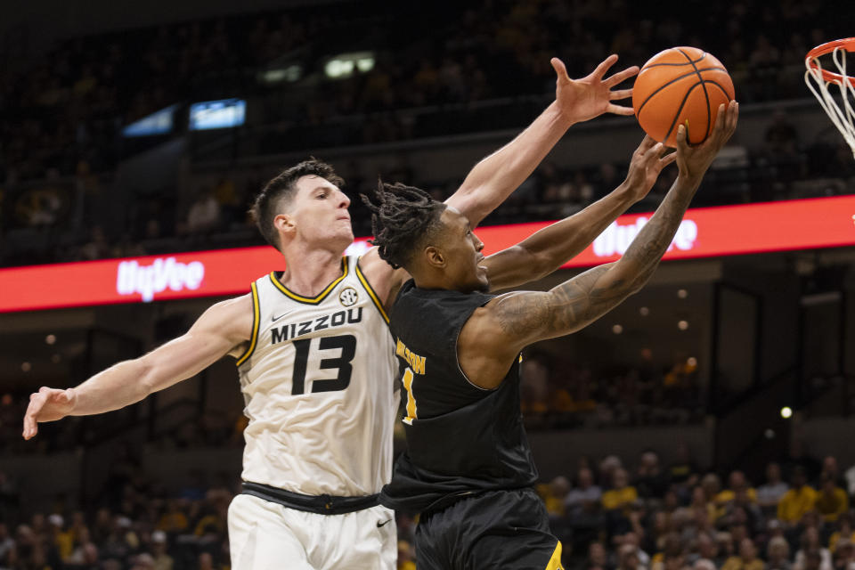 Missouri's Jesus Carralero Martin, left, tries to block the shot of Arkansas-Pine Bluff 's Kylen Milton, right, during the first half of an NCAA college basketball game Monday, Nov. 6, 2023, in Columbia, Mo. (AP Photo/L.G. Patterson)