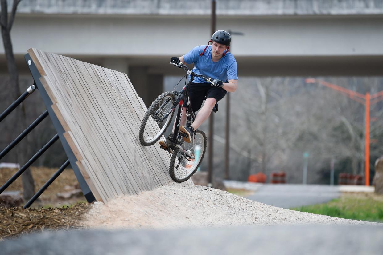 Dakota Bowling rides through the city’s expanded Urban Wilderness in the $10 million gateway park at the end of James White Parkway, Tuesday, March 9, 2021.